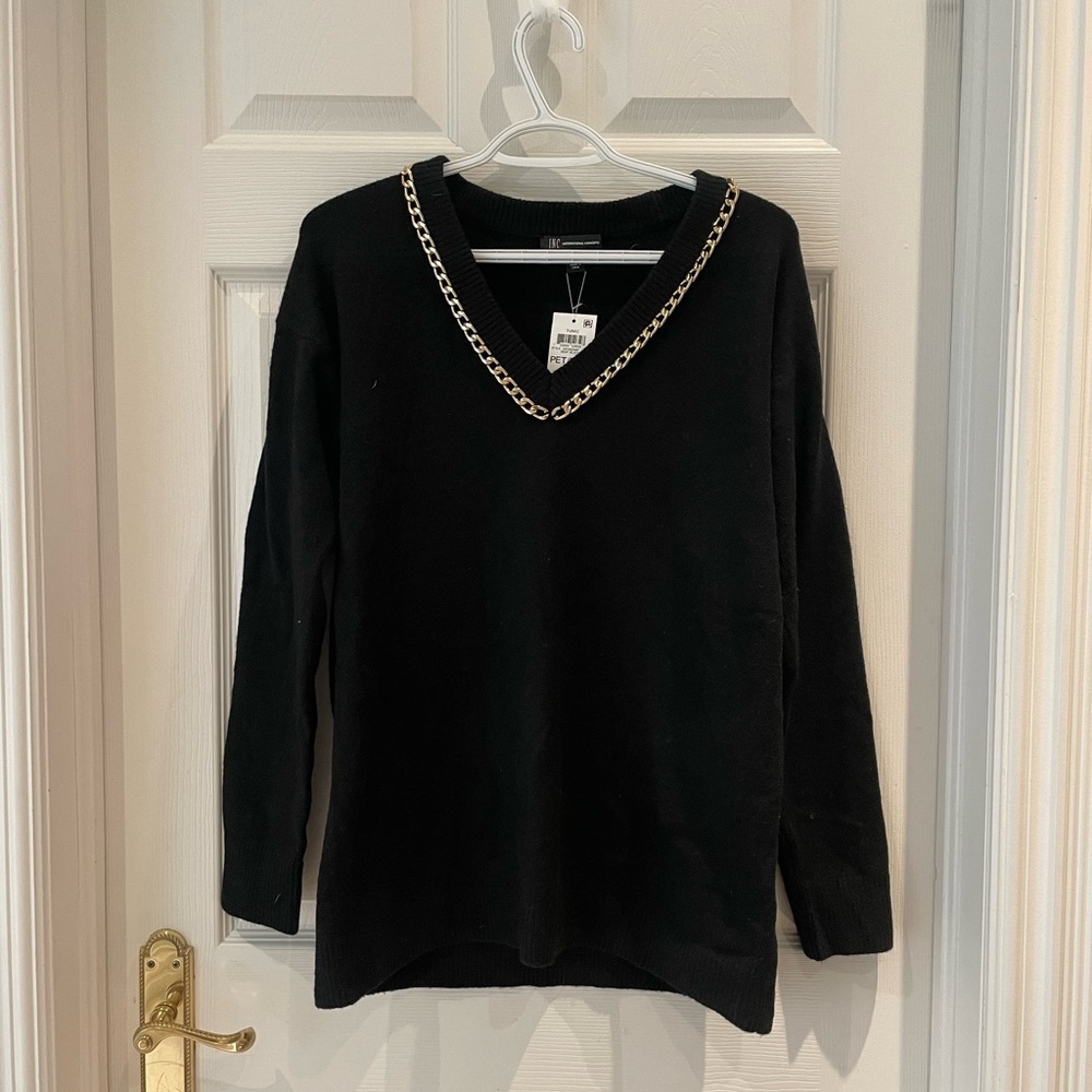 Woman’s black v neck sweater with gold
Chain
Bin 5